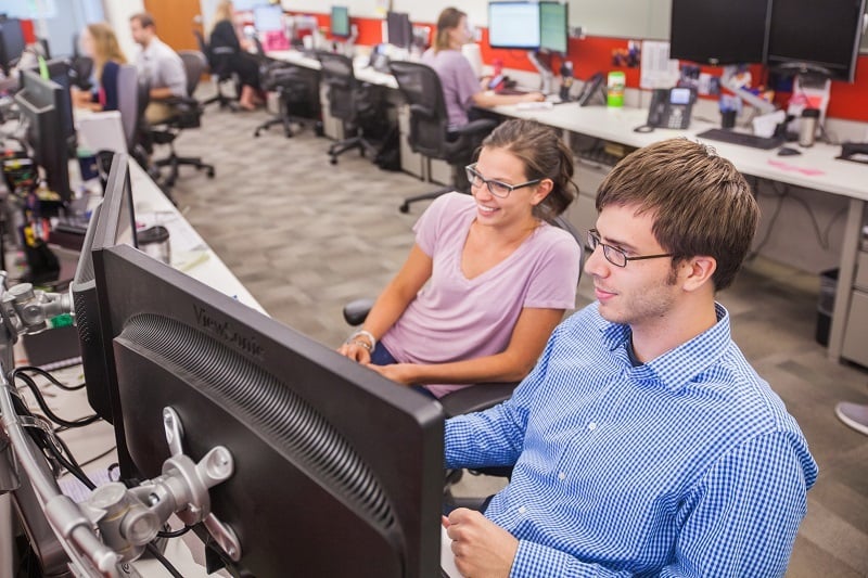 Railinc Customer Support Representative Kelli Buchanan working with a colleague.