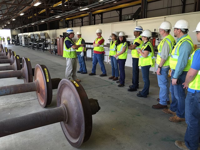 Railinc employees view worn wheelsets in a shop at CSX REDI.