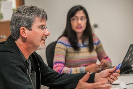 Railinc employees discussing rail data.