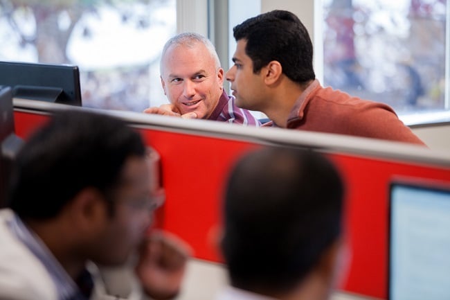 Railinc employees discussing a software development challenge.